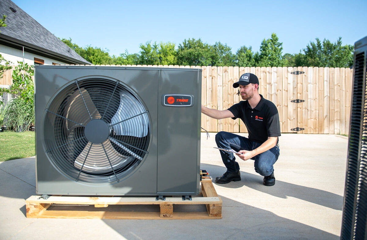HVAC technician working on an outdoor unit