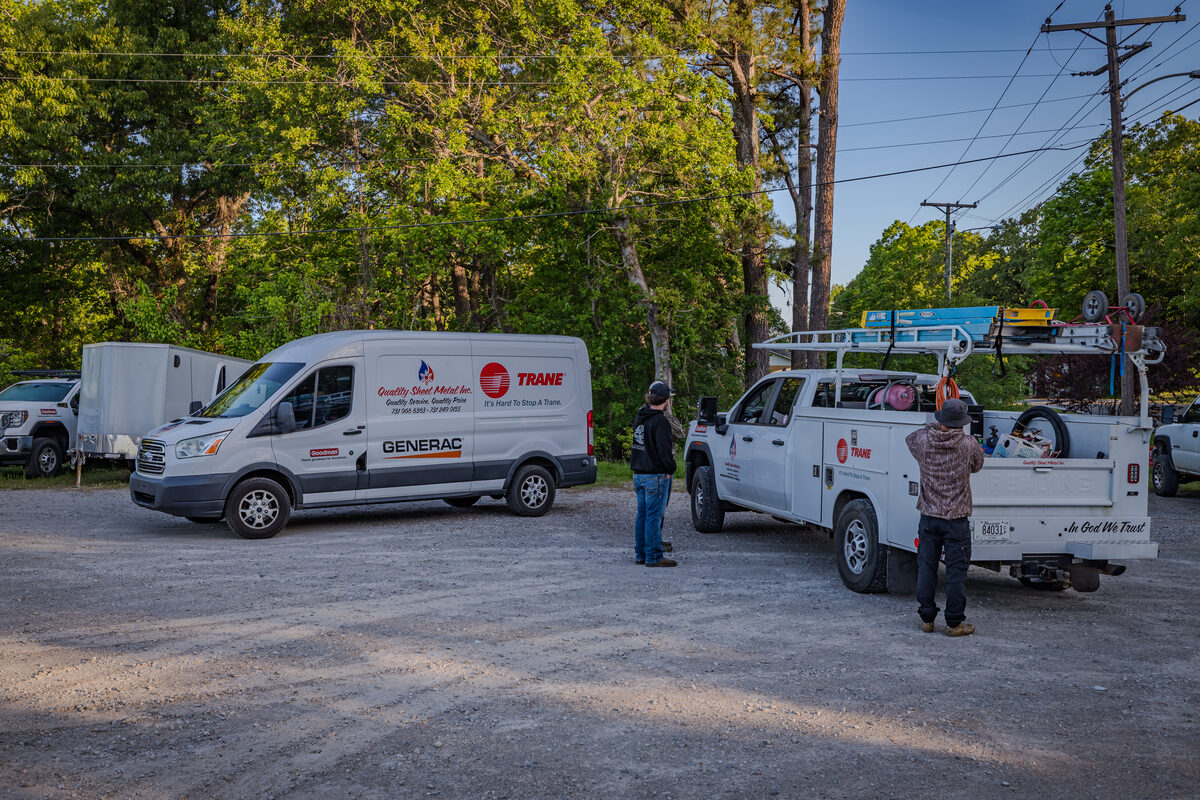 Quality Sheet Metal service van parked outside a home